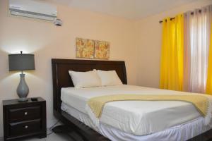 a bedroom with a bed and a lamp and a window at Jevico's Cozy Villa in Priory