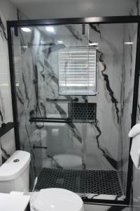 a bathroom with a shower with a toilet at Jevico's Cozy Villa in Priory +62 photos