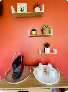a red wall with a table with a toaster on it at Villa du lac in Arsac