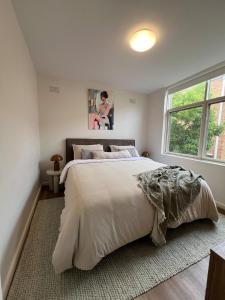 a bedroom with a large bed and a window at Fulton Flow Resort Apartment in Melbourne +13 photos