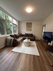 a living room with a couch and a table at Fulton Flow Resort Apartment in Melbourne +13 photos