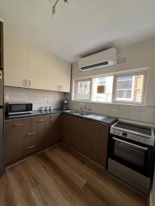 a kitchen with a sink and a stove top oven at Fulton Flow Resort Apartment in Melbourne