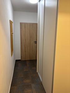 an empty hallway with a door and a tile floor at Apartmány Borovice in Josefŭv Dŭl +26 photos