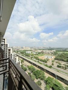a view of a city from a balcony at Sixty one stays in Greater Noida