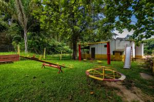 a group of playground equipment in a yard at Pousada Chalés Sierra in Serra Negra +3 photos