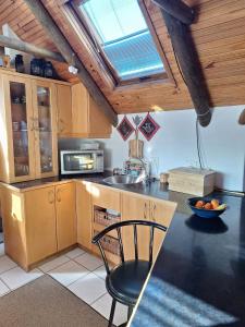 a kitchen with a table and a chair in it at See-Rus Self Catering Seaside Accommodation in Jacobs Bay