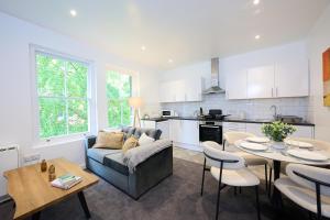 a living room with a couch and a table at 1A Central Bedford Apartment in Bedford