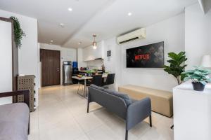 a living room with a couch and a table at Dominiks quite and Elegant Studio Ocean View Pool at Tambuli Resort High Floor in Maribago +53 photos