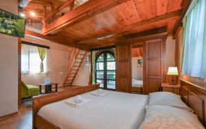 a bedroom with a large bed in a room with wooden ceilings at Kuća za odmor Mila in Tuheljske Toplice +29 photos