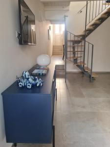 a room with a blue dresser and a staircase at La Casa del Moro Pachino in Pachino +19 photos