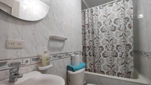 a bathroom with a sink and a shower curtain at Amoblados delicias norte chia in Chía