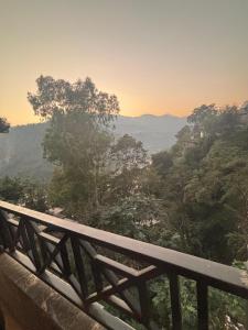 a view of a valley from a wooden bridge at bhagwati homestay in Chamba