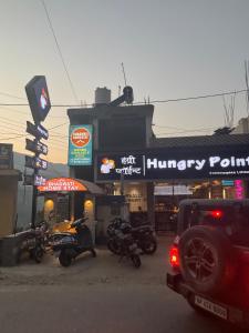 a group of motorcycles parked in front of a store at bhagwati homestay in Chamba +1 photo
