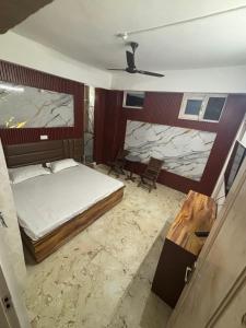 a bedroom with a bed and a stone wall at bhagwati homestay in Chamba