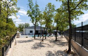 a group of trees in front of a fence at Villa Vanja in Imotski