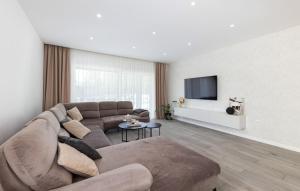 a living room with a couch and a flat screen tv at Villa Vanja in Imotski
