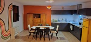 a kitchen with a table and chairs in it at Colorama in Nozay