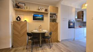 a kitchen and dining room with a table and chairs at Finestra su Lago in Genzano di Roma