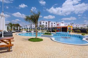 a resort with a swimming pool in a courtyard at Cozy 2 BR Tatu City - Unity Homes in Oloyaingalani