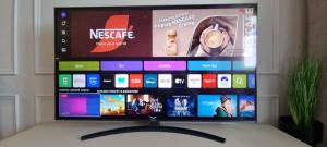 a flat screen tv sitting on top of a table at Prestige Apartment Oława in Oława