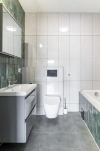 a bathroom with a toilet and a sink and a tub at Villach in Bukowina Tatrzańska