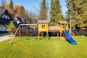 a playground in a yard with a slide at Villach in Bukowina Tatrzańska