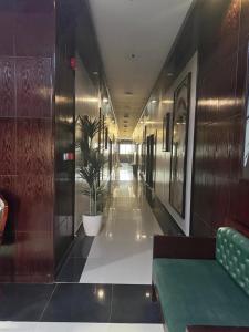 a hallway with a potted plant in a building at شقق النخبه الجوهره1 in Arar +2 photos