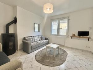 a living room with a couch and a table at Le Nid du Port in Étaples