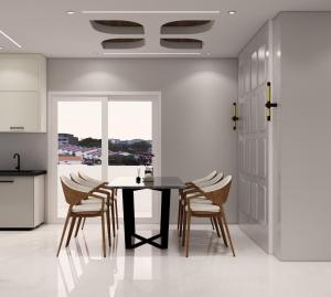 a kitchen and dining room with a table and chairs at Luxor in Hyderabad