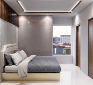 a bedroom with a bed and a window at Luxor in Hyderabad