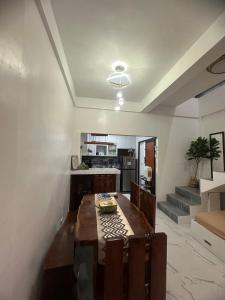 a kitchen and dining room with a table and chairs at Amado Apartelle 1 Tagaytay in Kaybagal