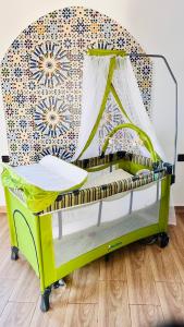 a yellow crib with a canopy in a room at Ferme royale Bensliman in O Ben Slimane +37 photos