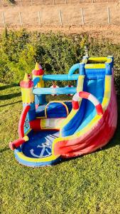 a colorful inflatable bounce house on the grass at Ferme royale Bensliman in O Ben Slimane