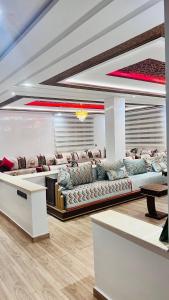 a living room with couches and a table at Ferme royale Bensliman in O Ben Slimane