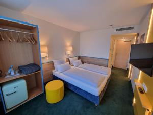 a hotel room with a bed and a tv at myMINGA13 - Hotel & serviced Apartments in Munich
