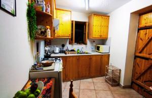 a kitchen with wooden cabinets and a counter with fruit on it at AsteriA 3D House Inn in Pano Arodes