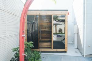 a small room with a door in a building at リトルバーズホステル in Omihachiman