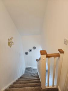 a staircase in a home with white walls at Trinity Guest House in Highbridge
