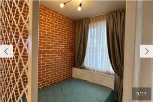 a room with a brick wall and a window at Le bijou-Tomov Plaza in Plovdiv