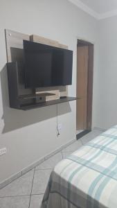 a flat screen tv on a wall in a room at Villa Serena in Nova Odessa