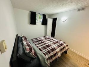 a bedroom with a bed in the corner of a room at Oscar's Retreat - 1Bedroom Apart in Moncton