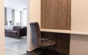 a living room with a chair and a couch at Joy City Stay Forest 54-85 in Dumbrăviţa