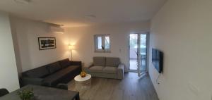 a living room with a couch and a chair at AiM in Kukljica