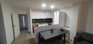 a small kitchen with a table and a sink in a room at AiM in Kukljica