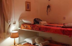 two bunk beds in a room with a lamp at AsteriA 3D House Inn in Pano Arodes