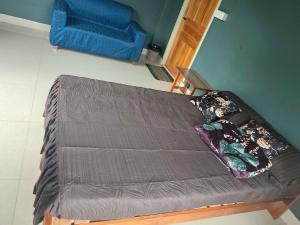 a futon bed in a room with a blue couch at Moonlight Homestay in Chaltlāng
