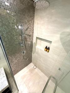 a bathroom with a shower with a glass door at KLCC Star Residences by Nexus 11 in Kuala Lumpur