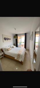 a bedroom with a large bed and a window at Sunset View Mojacar in La Marina de la Torre