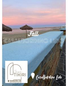 a view of a beach with an umbrella and the ocean at Casa Tikiri in Casalbordino