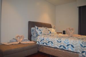 a bedroom with a bed with two slippers on it at Tambuli Seaside Living Tower F, Unit J Level 15 in Maribago